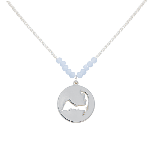 the beach and back cape cod necklace in silver with pale blue beads at center of chain and coin shape pendant with cutout silhouette of cape cod
