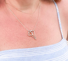 Load image into Gallery viewer, wearing gold captiva shell pendant necklace with light blue and white stripes