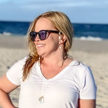 Load image into Gallery viewer, mantoloking charm necklace with white opal pendant freshwater stick pearl and starfish charm on model  standing on beach