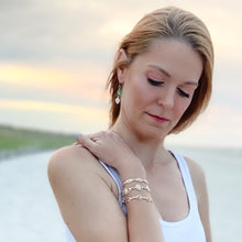 Load image into Gallery viewer, ocean springs oval  abalone shell and organic oval shape freshwater pearl earrings on  model
