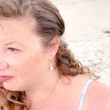 Load image into Gallery viewer, ocean springs organic pear shape pearl earrings on founder of the beach and back
