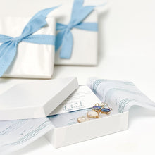 Load image into Gallery viewer, the beach and back gift wrap with signature wave and sea gull pattern  tissue paper with white paper wrap and turquoise ribbon bow
