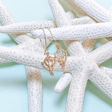 Load image into Gallery viewer, single drop gold conch shell earrings on loop wire on aqua background with white seastars
