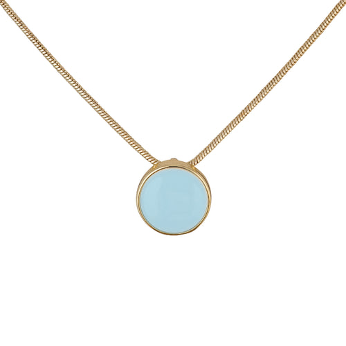 a small circular pendant with a gold bezel set crisp aqua enamel center. The pendant hangs from a gold-plated brass snake chain. and has a white background.