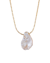 Load image into Gallery viewer, A close-up photo of a single strand gold chain necklace with one single keshi or petal pearl, irregularly-shaped Keshi pearl. The pearl strung on a thin, delicate chain and fastened with a small clasp. The necklace is laid out against a white background.
